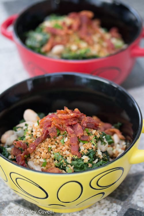 Bowls of kale and white beans with crunchy bacon panko topping.