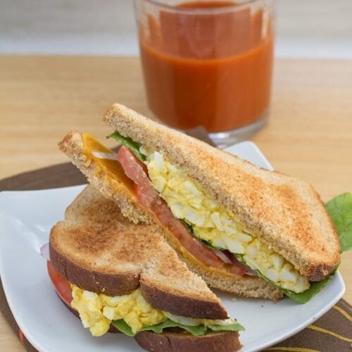 Egg salad sandwich sliced in half.
