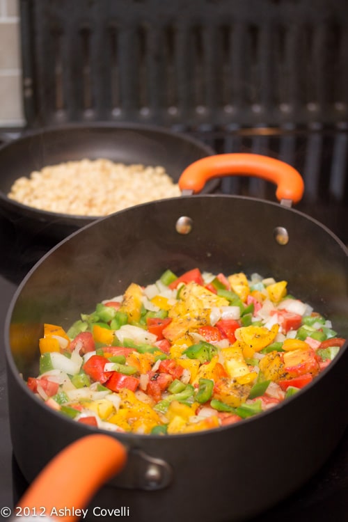 Colorful mix of veggies being cooked on the stovetop.