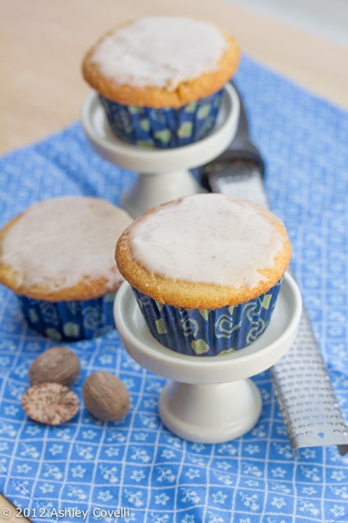 Nutmeg cupcakes with whole nutmeg and a microplane alongside.