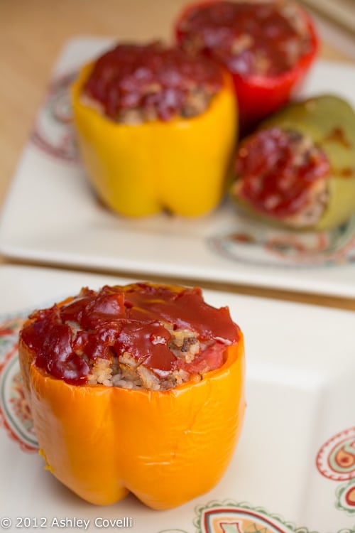 Stuffed bell peppers topped with ketchup.