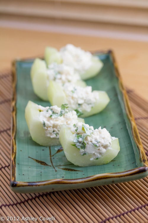 Stuffed cucumber slices on a plate.