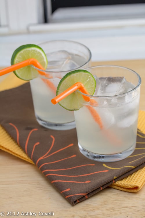 Moscow mules in glasses with orange straws and lime wheels.