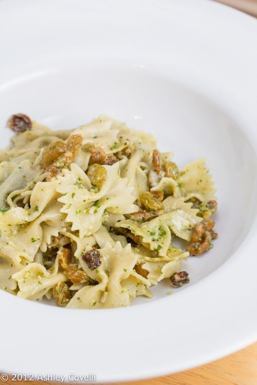 Bowl of farfalle with arugula-walnut pesto.