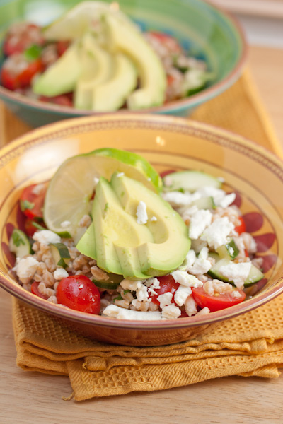 Bowls of chilled farro salad with avocado and feta.