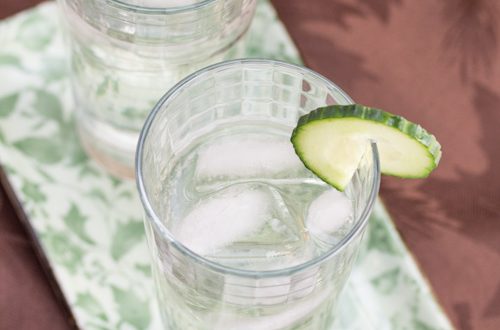 Gin cocktails garnished with lime.