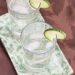 Gin cocktails garnished with lime.