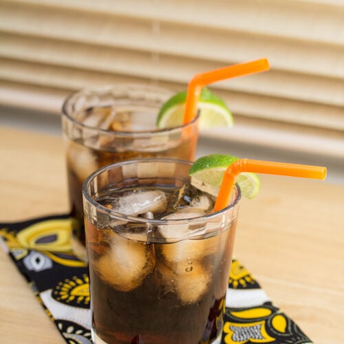 Cola cocktails garnished with lime wedges.