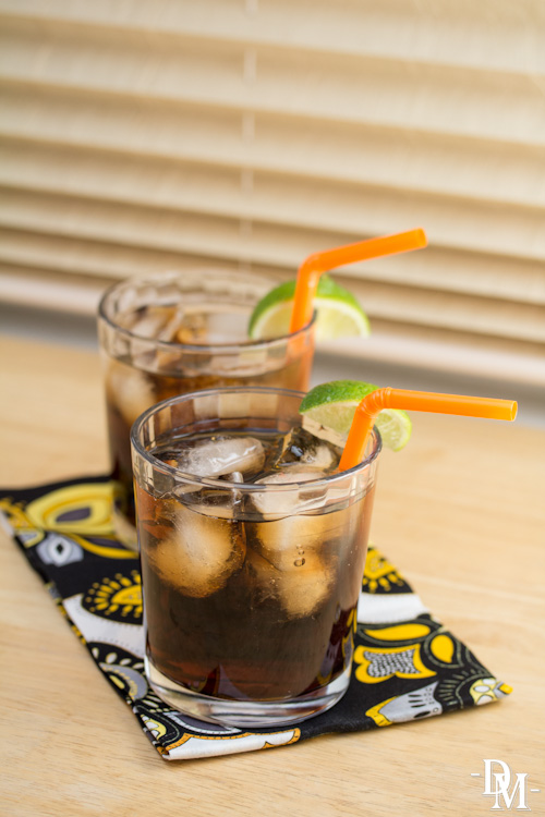 Cola cocktails garnished with lime wedges.