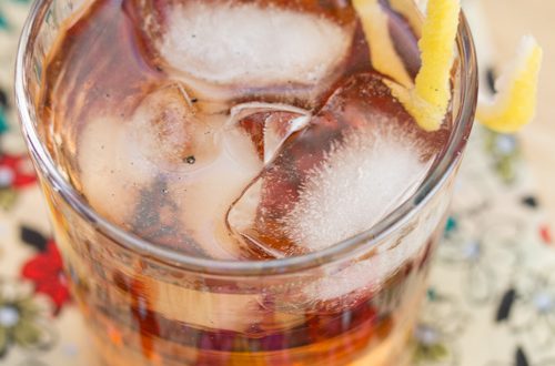 Bourbon cocktail garnished with a lemon twist.