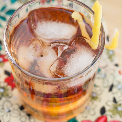 Bourbon cocktail garnished with a lemon twist.