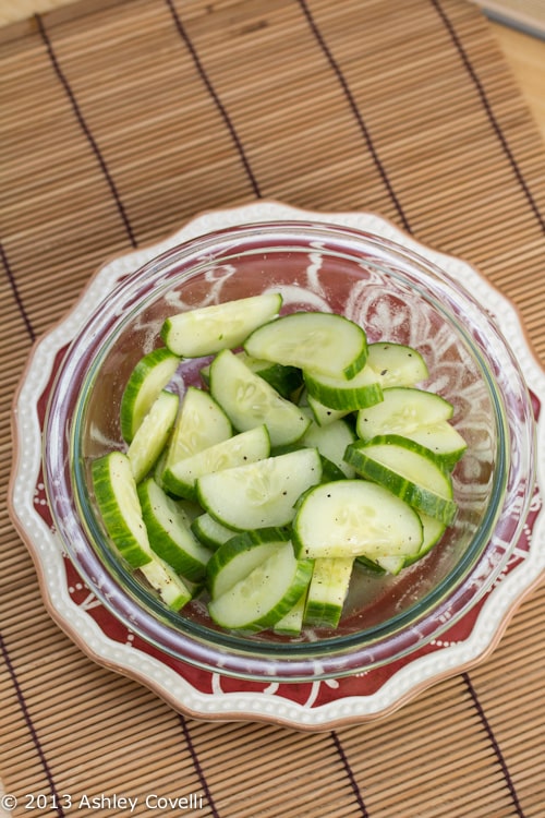 Overhead view of a bowl of sweet and sour cucumber salad.