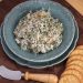 Caramelized Onion and Spinach Dip with Sage in a bowl with crackers.