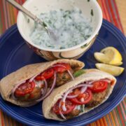 Falafel in pita bread with toppings served with yogurt-herb sauce.