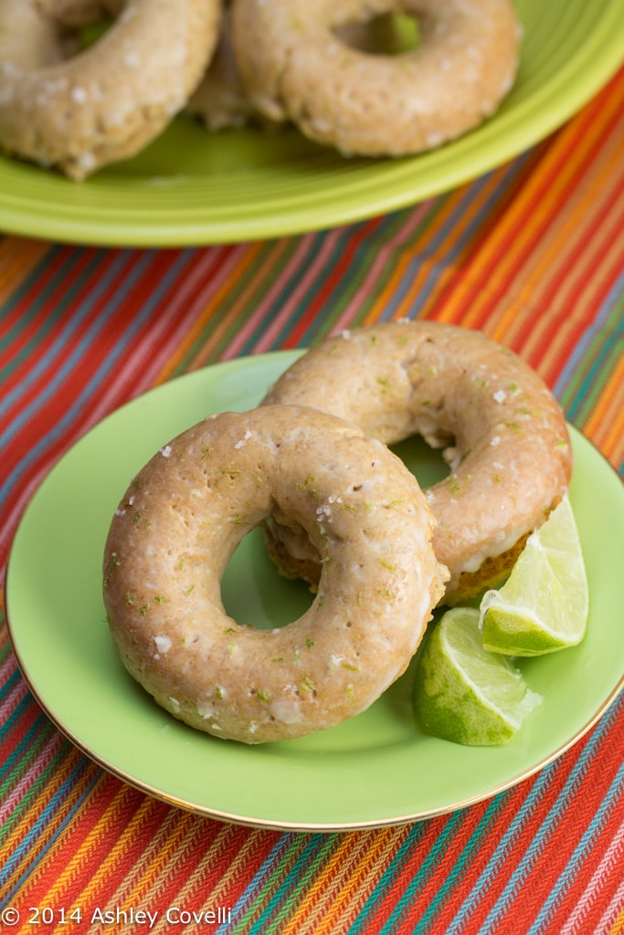 Margarita Donuts on a plate with lime wedges.