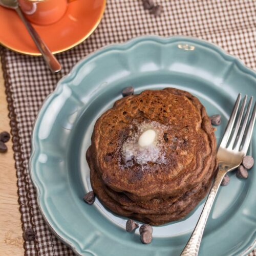Mocha Chip Pancakes on a plate with a cup of espresso.