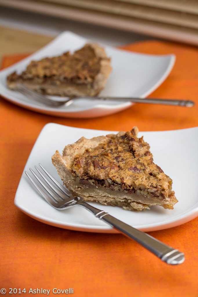 Plates with slices of bourbon bacon pecan pie.