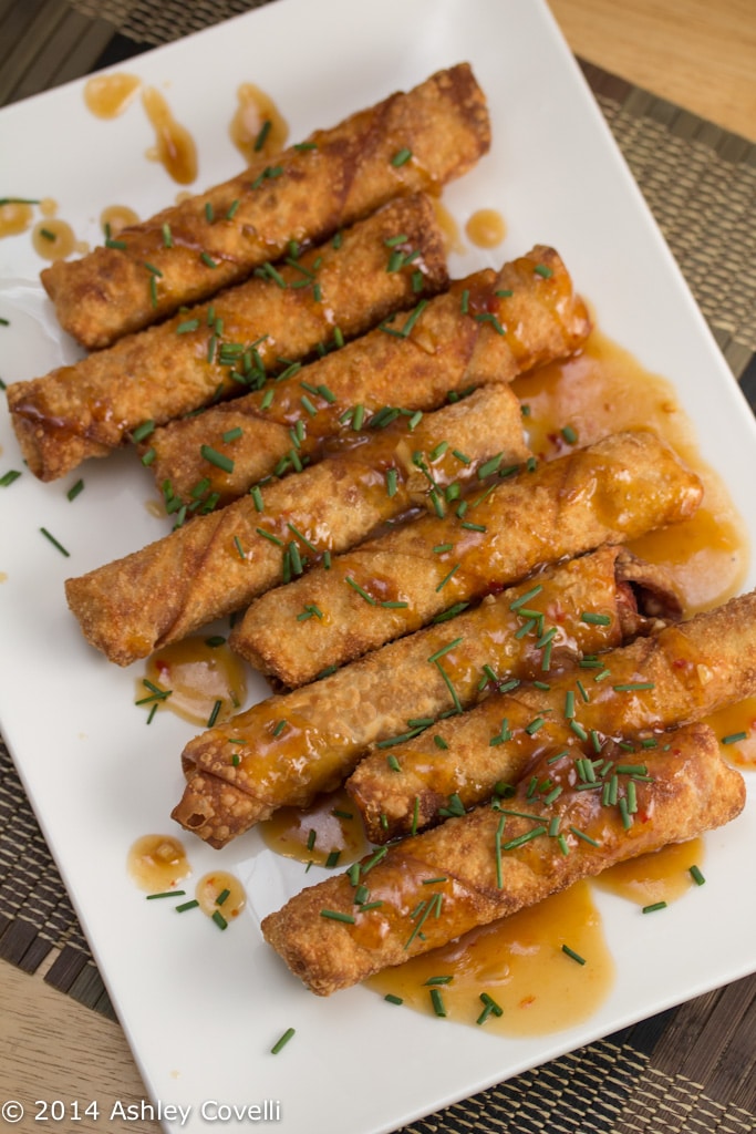 Platter of fried hot dogs sprinkled with chives.