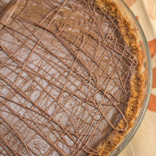Triple-Chocolate Pumpkin Pie - Graham cracker crust is slathered with a layer of bittersweet chocolate that's hidden beneath a pumpkin & semi-sweet chocolate filling. Sure to be your new Thanksgiving holiday favorite!