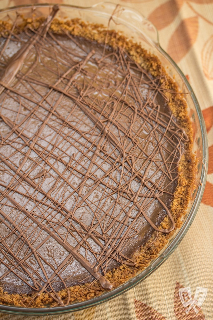 Triple-Chocolate Pumpkin Pie - Graham cracker crust is slathered with a layer of bittersweet chocolate that's hidden beneath a pumpkin & semi-sweet chocolate filling. Sure to be your new Thanksgiving holiday favorite!