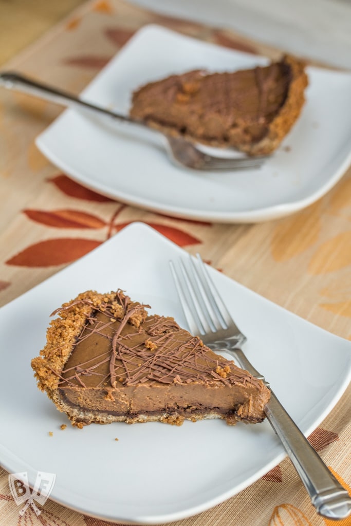 Triple-Chocolate Pumpkin Pie - Graham cracker crust is slathered with a layer of bittersweet chocolate that's hidden beneath a pumpkin & semi-sweet chocolate filling. Sure to be your new Thanksgiving holiday favorite!