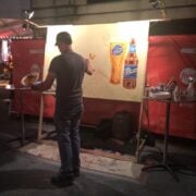 Artist painting a beer-themed mural.