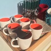 Coffee cups and utensils on a table.
