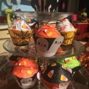 Papercraft Halloween cupcakes on a display.