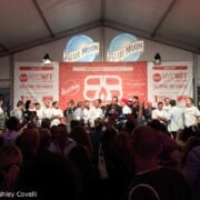 A group of people standing in front of a crowd.