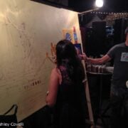 People painting a beer-themed mural.