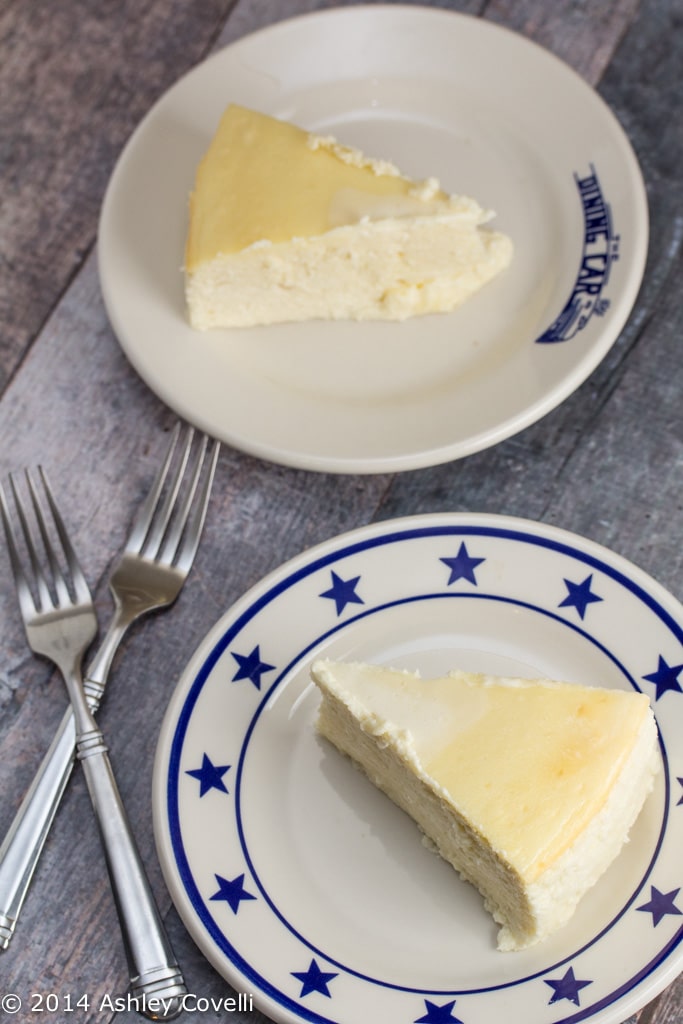 Two plates with slices of Italian cream cheese and ricotta cheesecake.