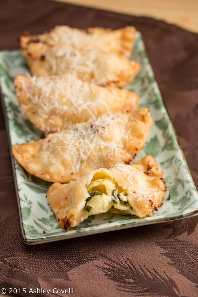 Platter of fried dumplings with macaroni and cheese inside.