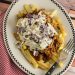 Bar-B-Q Pulled Pork Fries with Cole Slaw on a plate with a fork.