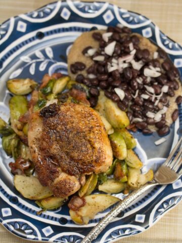 Plate of Chicken Thighs with Bacon, Brussels Sprouts and Easy Apple Jus.