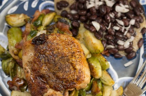 Plate of Chicken Thighs with Bacon, Brussels Sprouts and Easy Apple Jus.