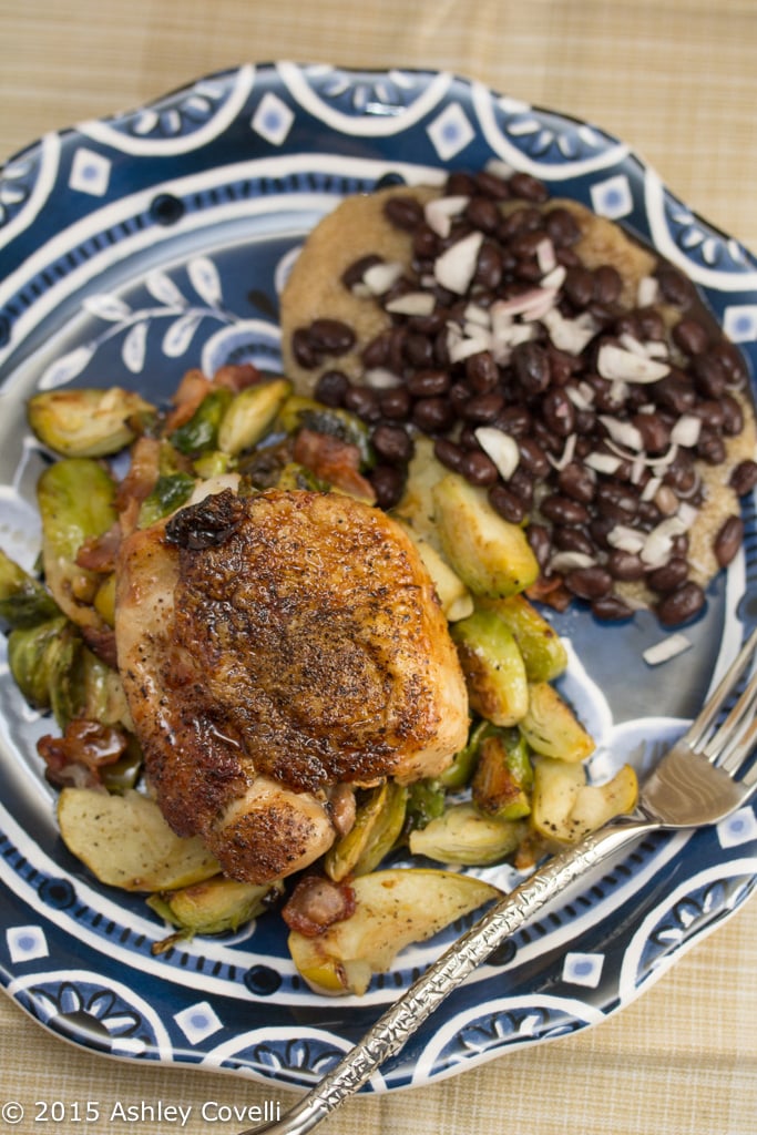 Plate of Chicken Thighs with Bacon, Brussels Sprouts and Easy Apple Jus.