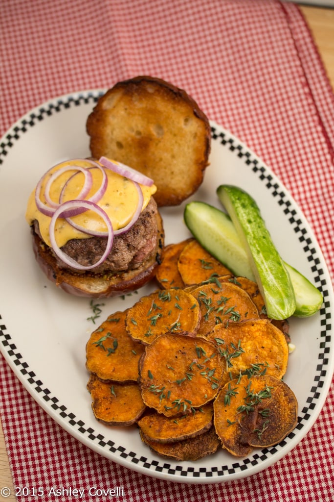 Short Rib Burgers on Pretzel Buns with Hoppy Cheddar Sauce & Roasted Sweet Potato Rounds