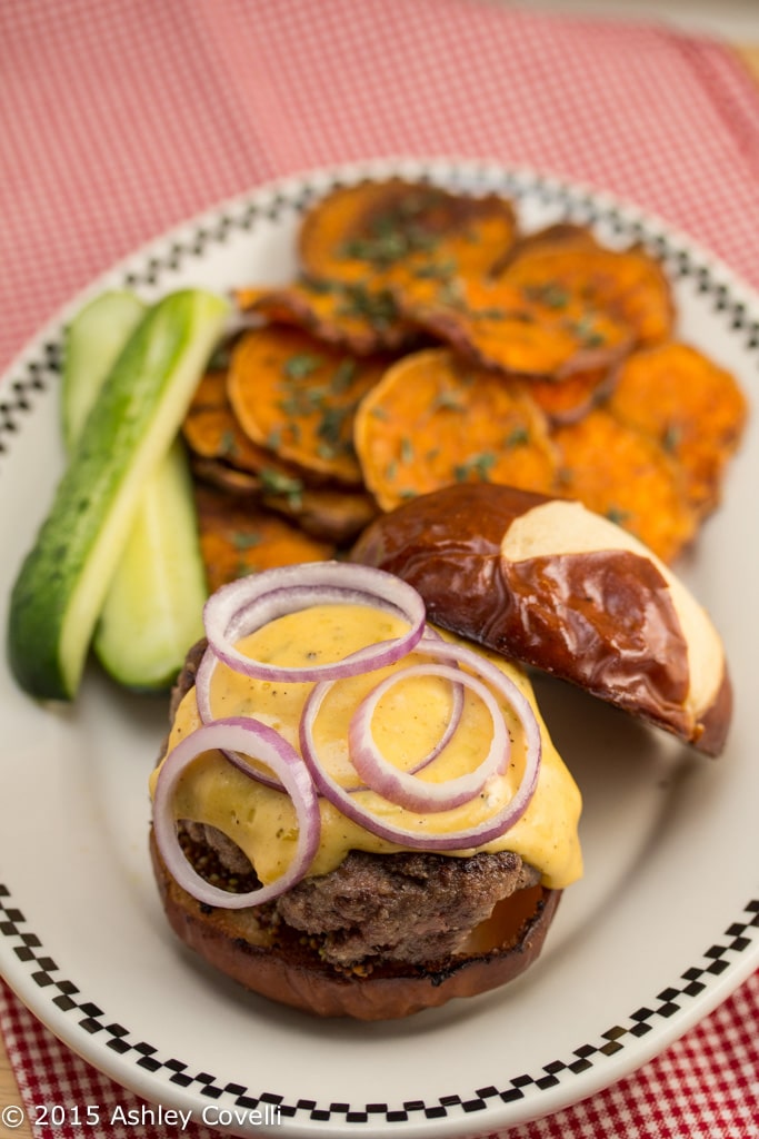 Short Rib Burgers on Pretzel Buns with Hoppy Cheddar Sauce & Roasted Sweet Potato Rounds