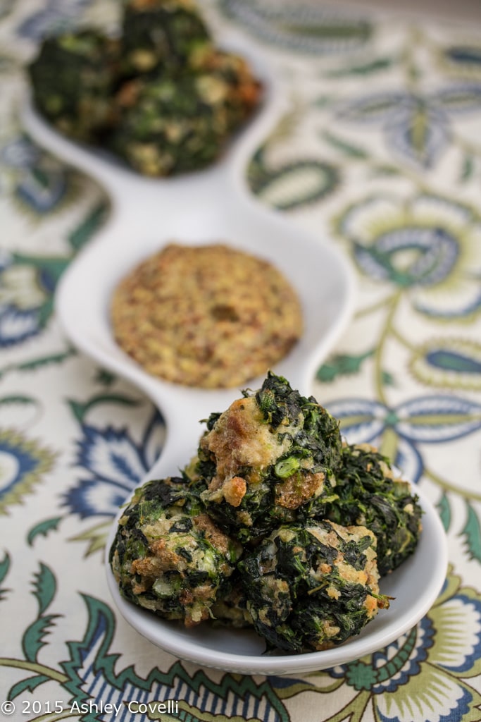 Spinach balls with grainy mustard for dipping.