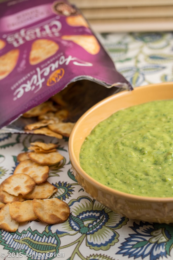 Bowl of vibrant green chimi-verde dip with naan crisps alongside.