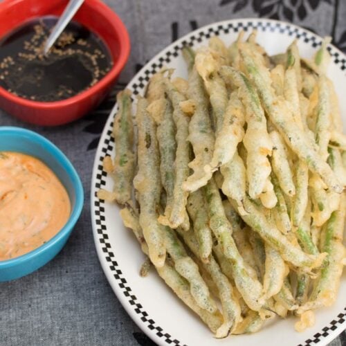 Overhead view of Tempura Green Beans with Sriracha Aioli + Soy Ginger Dipping Sauces.