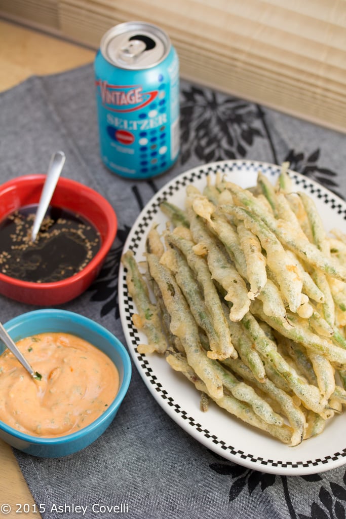 Overhead view of Tempura Green Beans with Sriracha Aioli + Soy Ginger Dipping Sauces.