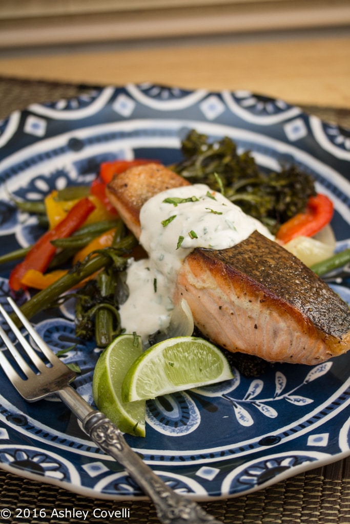 Crispy Skinned Salmon Over Roasted Veggies with Cilantro Mint Yogurt Sauce