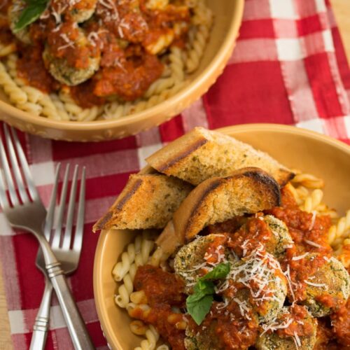 Overhead view of 2 bowls of Italian-Style Veggie Polpette with garlic bread.