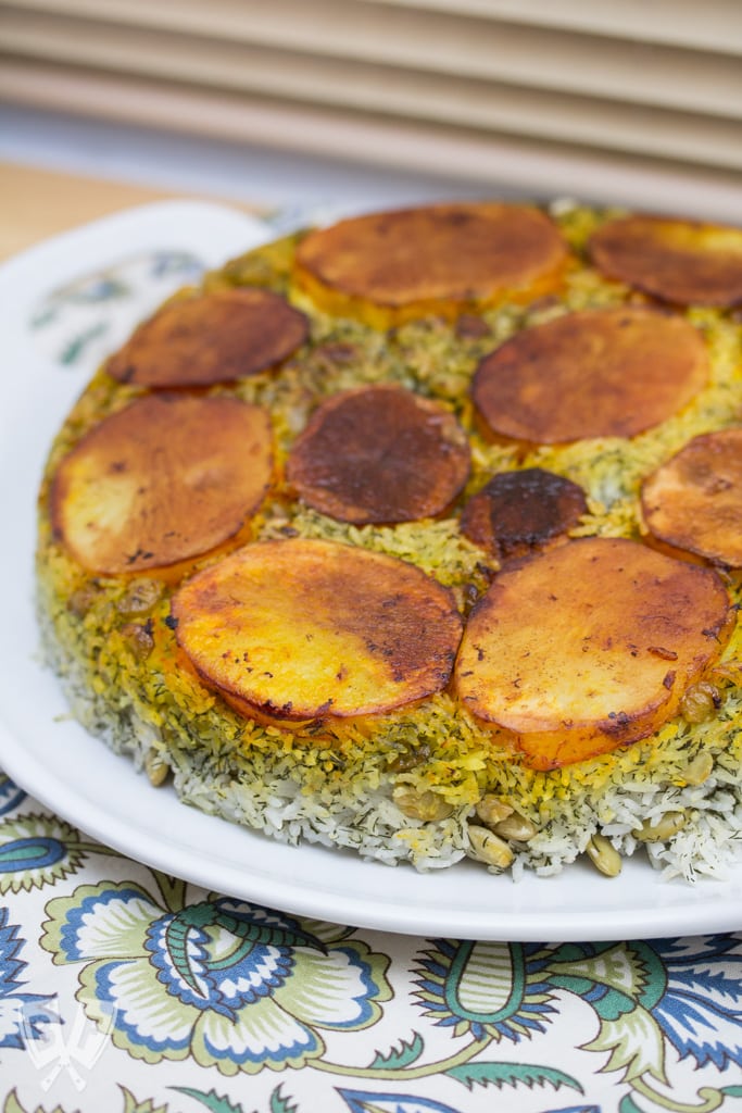 Polo Shevid Baghali (Persian Dill + Lima Bean Rice): Potatoes are fried in a buttery saffron mixture that help form a beautifully golden crust when this fragrant rice dish is turned out onto a platter. #ad