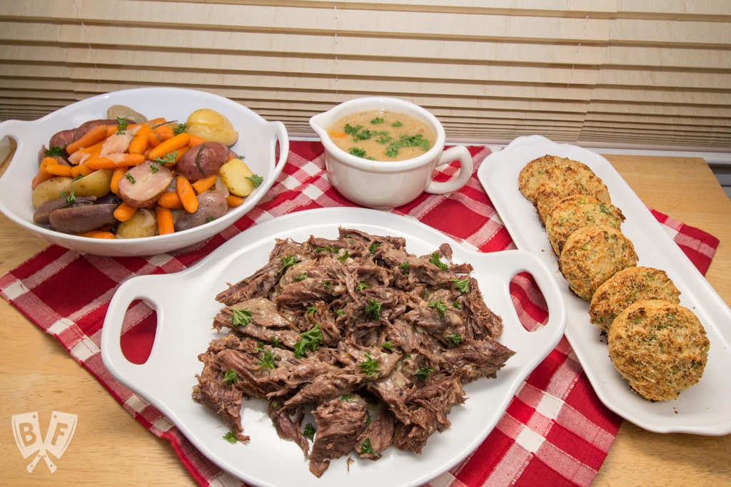 Platters of Instant Pot Herbed Pot Roast with veggies and gravy.