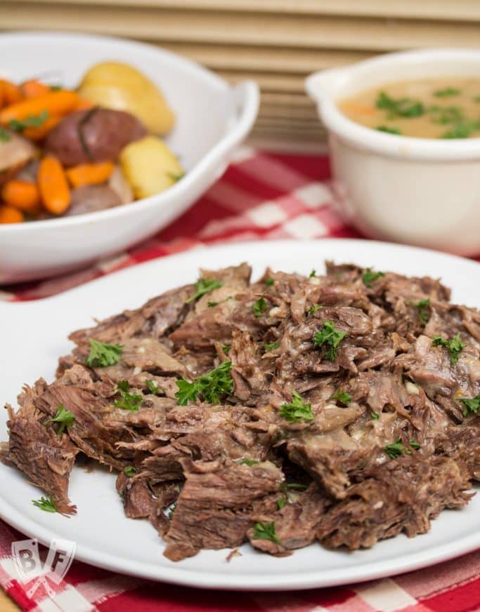 Platters of pot roast, veggies, and gravy.