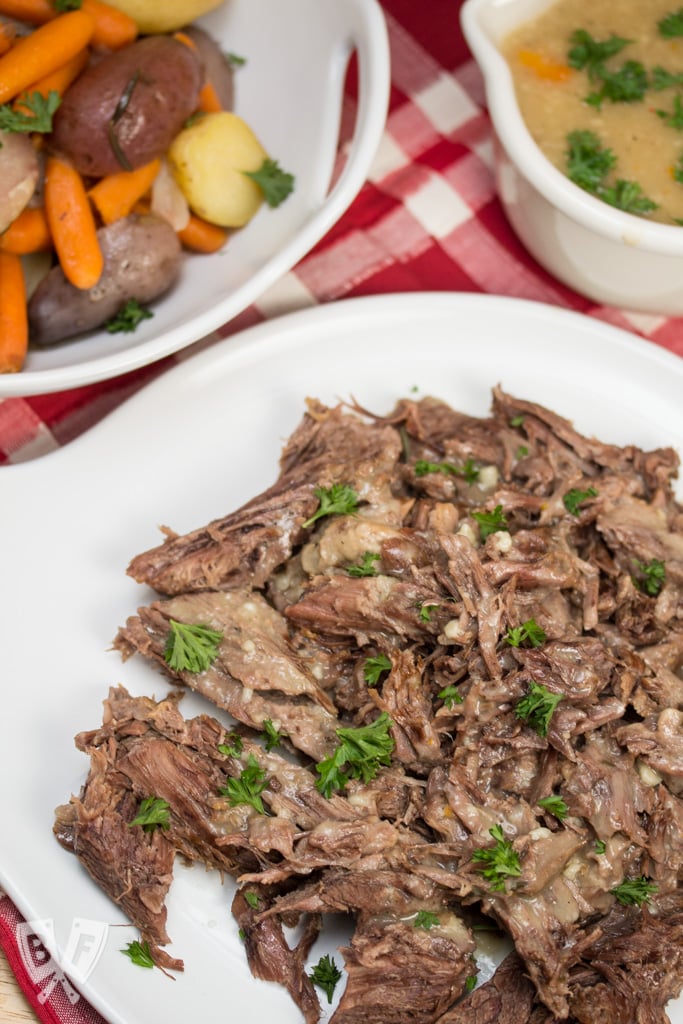 Platters of Instant Pot Herbed Pot Roast with veggies and gravy.