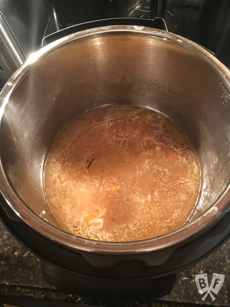 Overhead view of pot roast drippings in an Instant Pot.