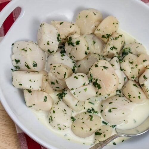 Serving bowl of Julia Child's Wine Poached Sea Scallops.